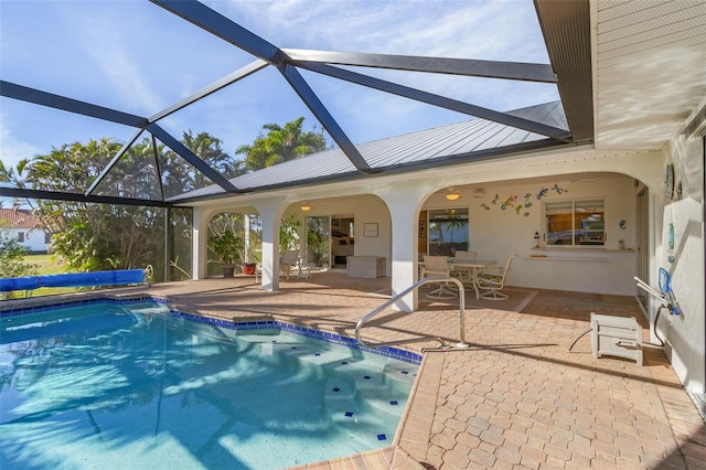 view of swimming pool with a lanai and a patio area