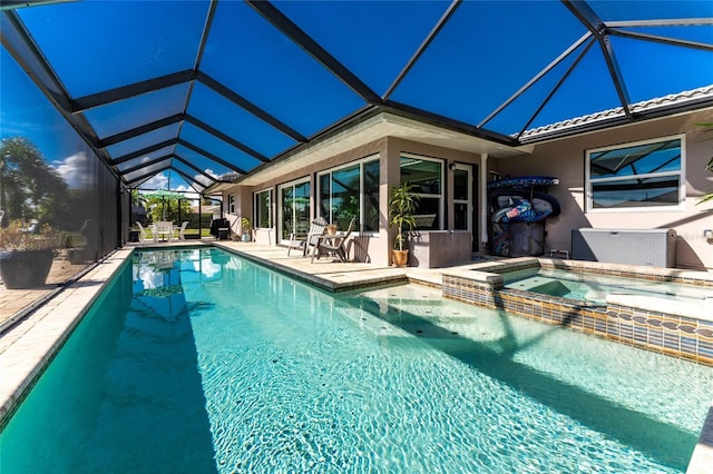 view of swimming pool featuring a lanai, an in ground hot tub, and a patio