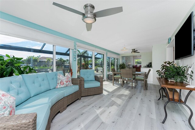 sunroom / solarium featuring ceiling fan and a healthy amount of sunlight