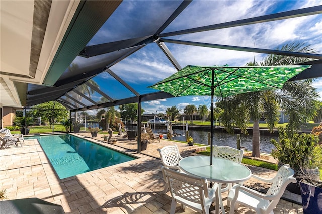 view of pool featuring a boat dock, a water view, glass enclosure, and a patio area