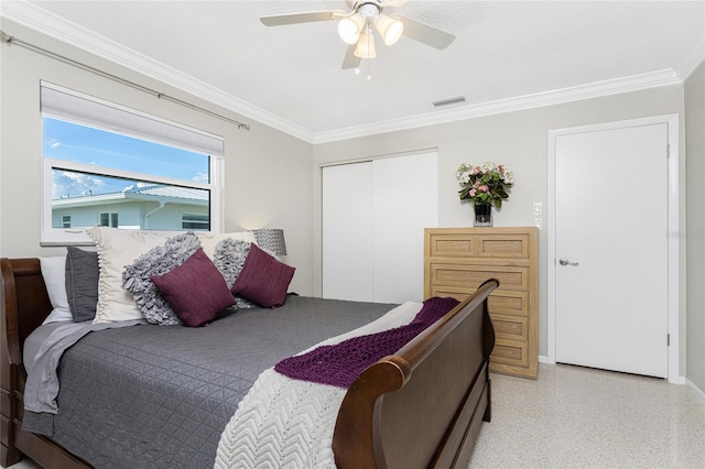 bedroom featuring a textured ceiling, a closet, ceiling fan, and crown molding