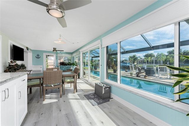 sunroom featuring a wealth of natural light and ceiling fan