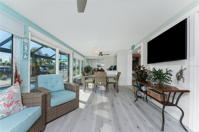 sunroom featuring ceiling fan