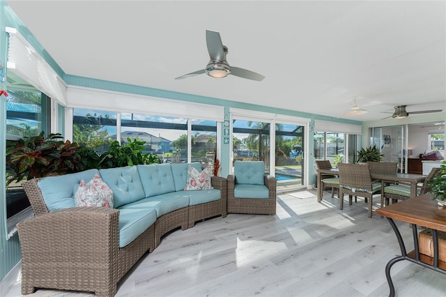 sunroom / solarium featuring ceiling fan and plenty of natural light