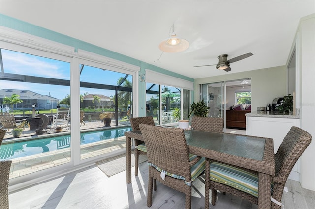 dining space featuring ceiling fan and light wood-type flooring