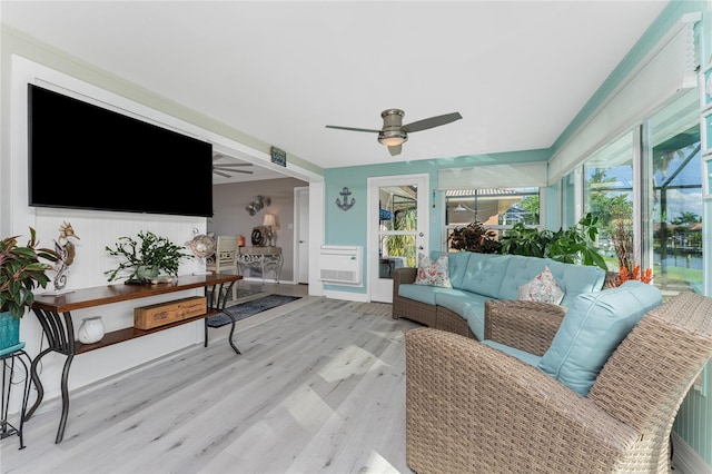 living room with ceiling fan, light hardwood / wood-style floors, and a healthy amount of sunlight