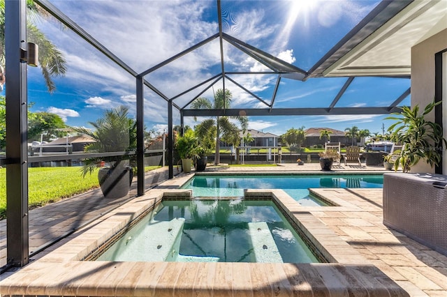 view of swimming pool with glass enclosure, a patio area, and an in ground hot tub