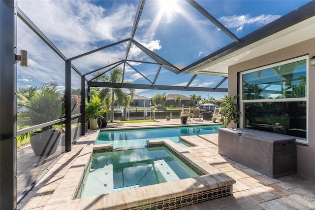 view of swimming pool featuring a lanai, an in ground hot tub, and a patio