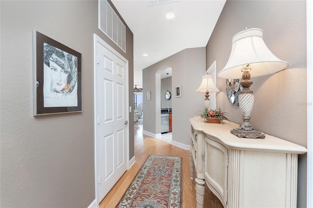 hallway with light hardwood / wood-style floors