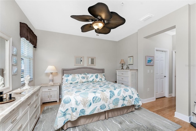 bedroom with light hardwood / wood-style floors and ceiling fan