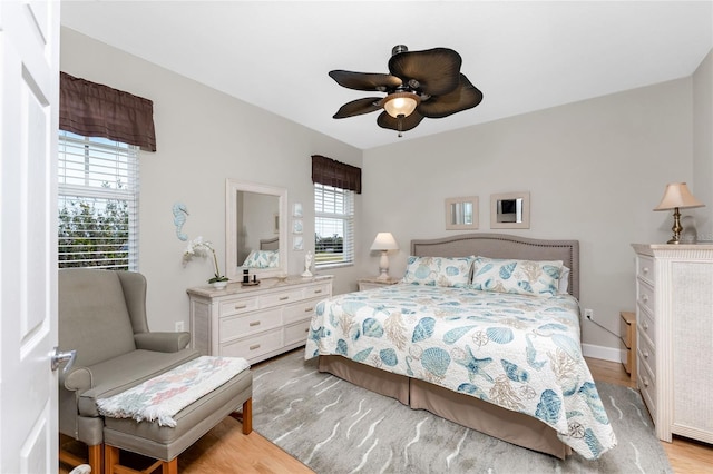 bedroom featuring light hardwood / wood-style floors and ceiling fan