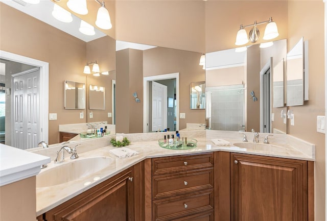 bathroom featuring a shower, vanity, and an inviting chandelier