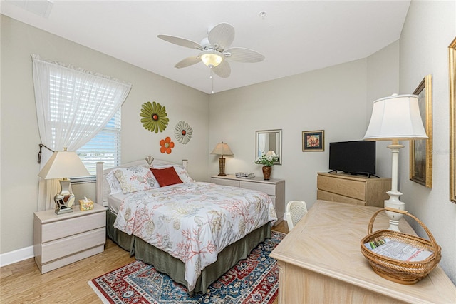 bedroom with ceiling fan and hardwood / wood-style flooring