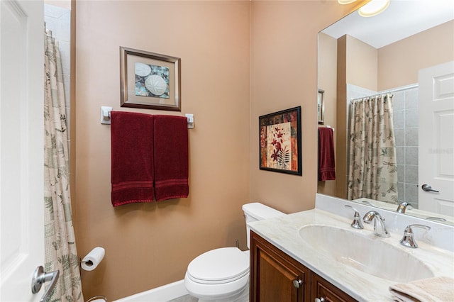 bathroom featuring vanity, toilet, and curtained shower