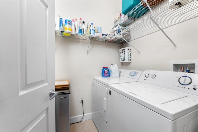 washroom with separate washer and dryer and light tile patterned floors