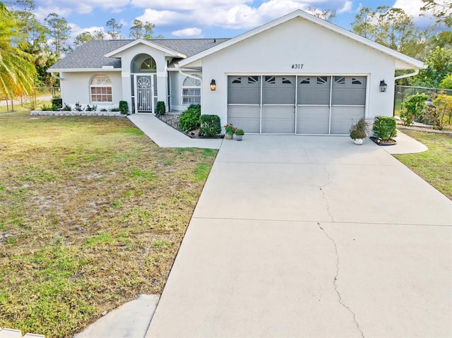 single story home featuring a garage and a front lawn