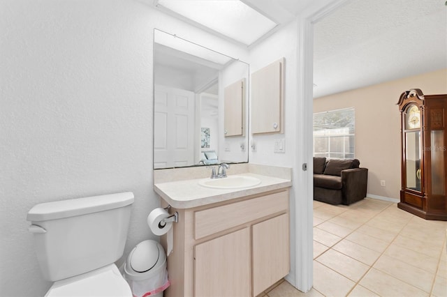 bathroom with tile patterned floors, vanity, and toilet