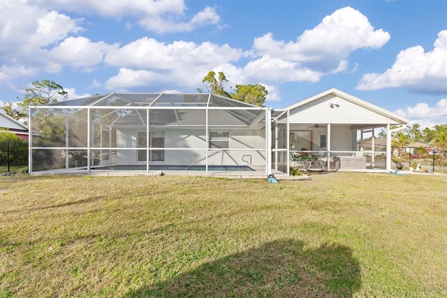 rear view of property featuring a lawn and glass enclosure