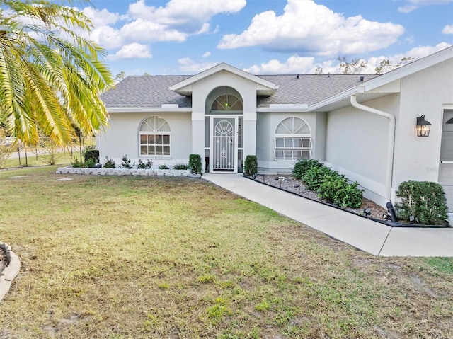 ranch-style house with a garage and a front yard