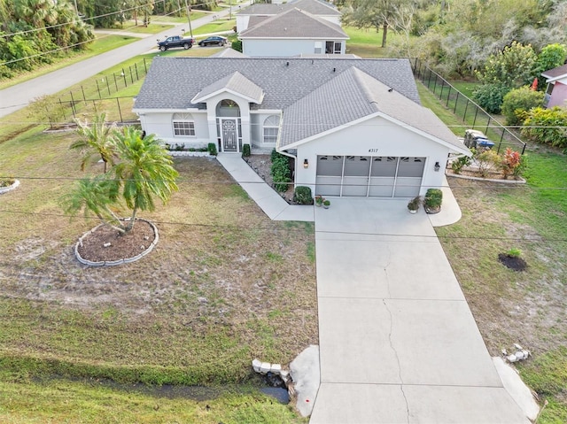 ranch-style house with a front yard and a garage