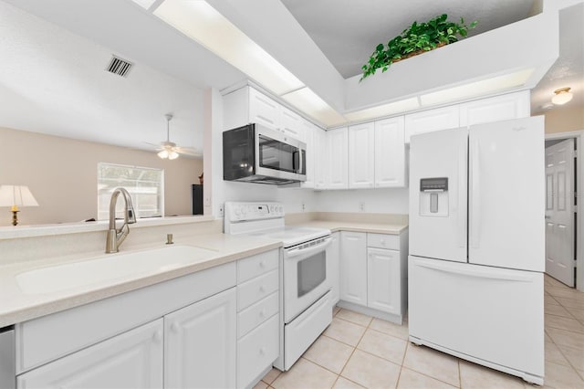 kitchen with white appliances, ceiling fan, sink, light tile patterned floors, and white cabinetry