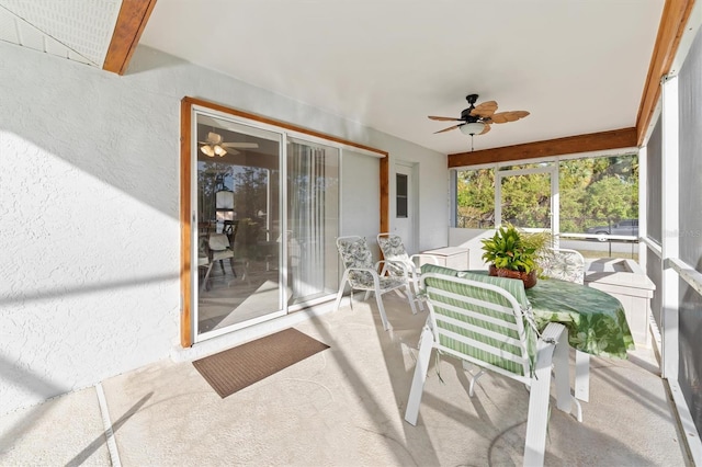 sunroom / solarium featuring ceiling fan