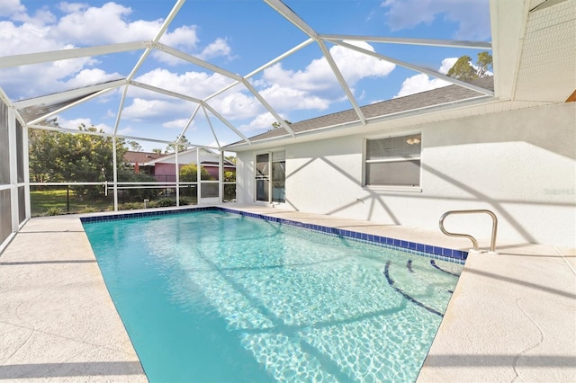 view of pool with glass enclosure