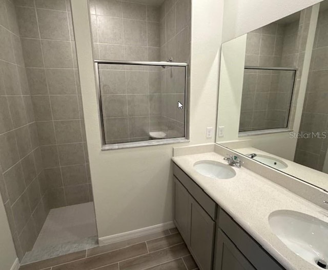 bathroom featuring a tile shower and vanity