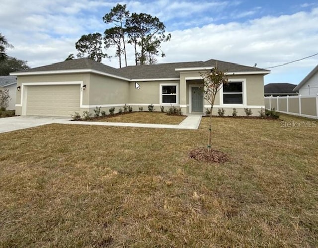 view of front of home featuring a garage and a front lawn