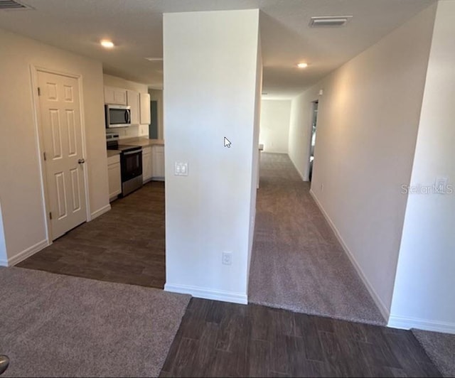 hallway featuring dark hardwood / wood-style flooring