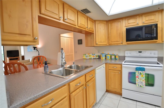 kitchen featuring sink, light brown cabinetry, white appliances, and light tile patterned flooring