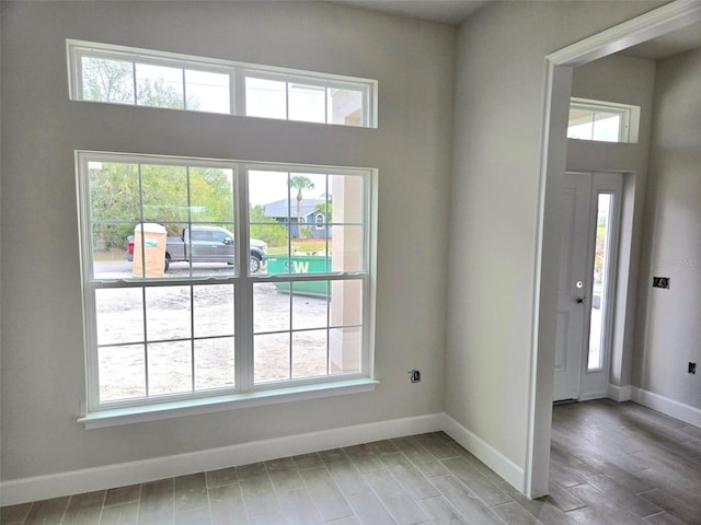 entryway with baseboards and wood finished floors