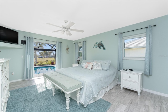 bedroom with ceiling fan, multiple windows, and light hardwood / wood-style flooring