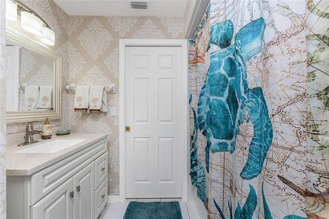 bathroom featuring tile patterned flooring and vanity