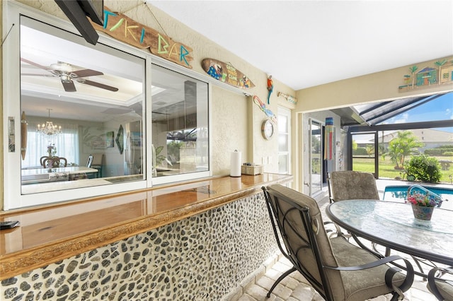 dining space featuring ceiling fan with notable chandelier