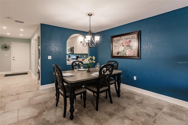 dining area with an inviting chandelier