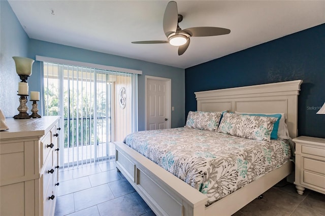 bedroom featuring access to outside, ceiling fan, and dark tile patterned floors