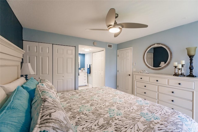 bedroom with ceiling fan and multiple closets