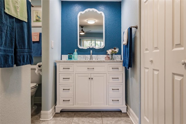 bathroom featuring ceiling fan, tile patterned flooring, vanity, and toilet