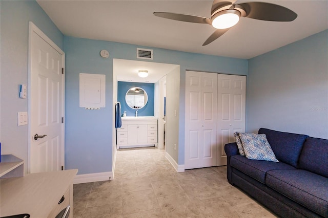 tiled living room with ceiling fan