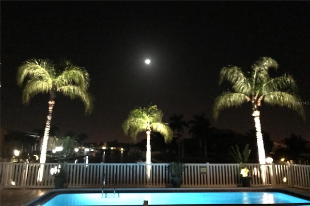 view of pool at night