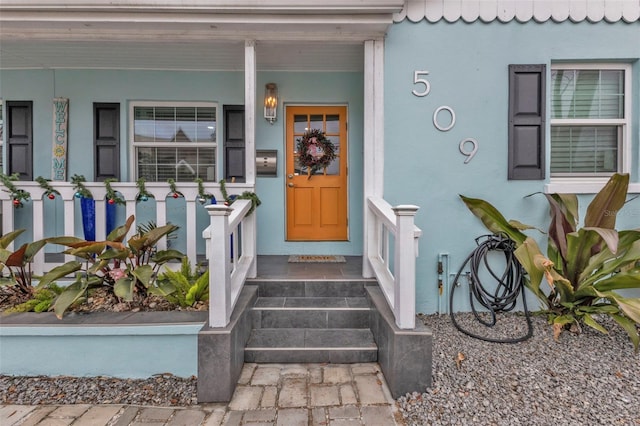 doorway to property featuring covered porch