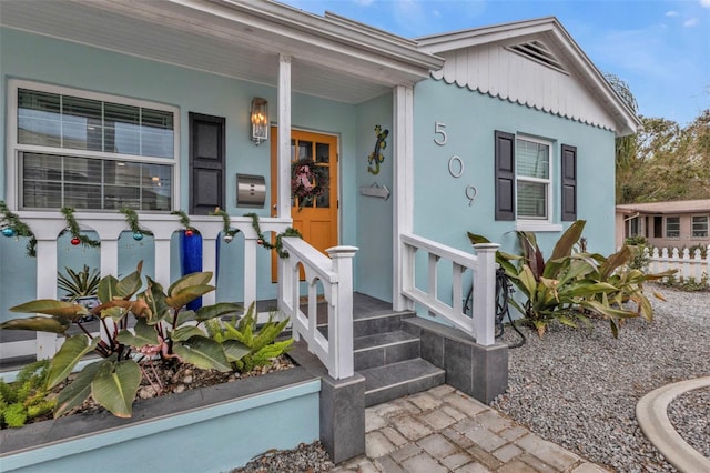 view of exterior entry with covered porch