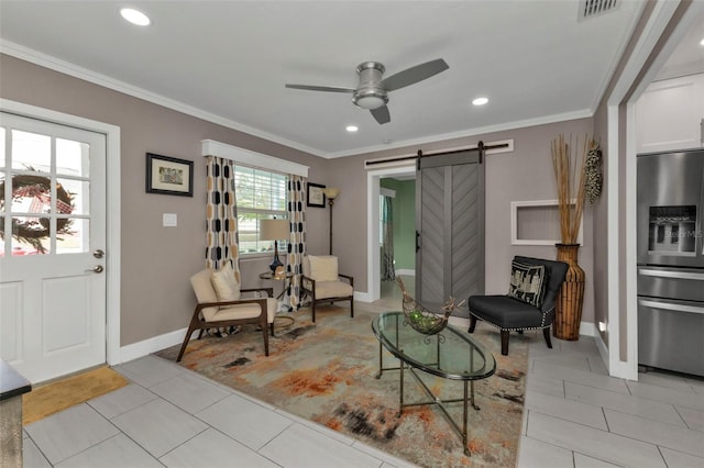 living room featuring a barn door, a healthy amount of sunlight, and ornamental molding