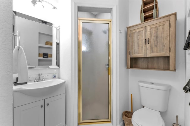 bathroom with vanity, an enclosed shower, and toilet