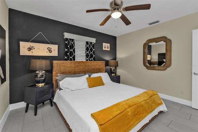 bedroom with tile patterned floors and ceiling fan