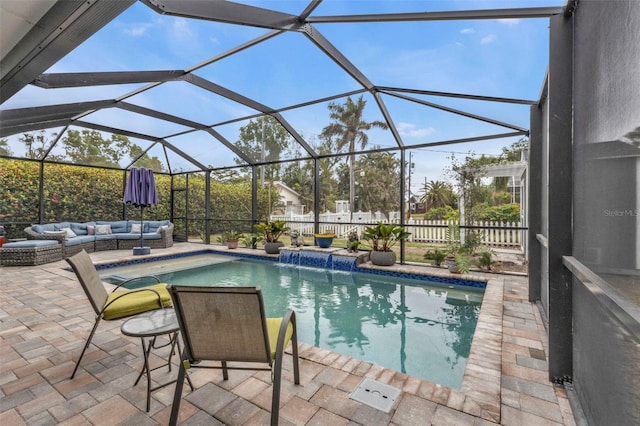 view of pool with a lanai, pool water feature, a patio, and an outdoor hangout area