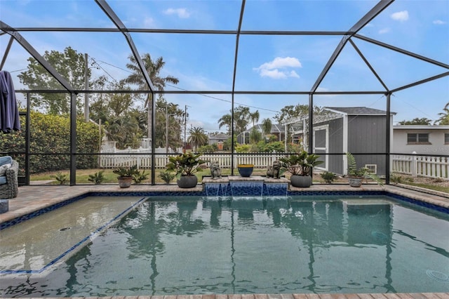 view of pool featuring pool water feature, glass enclosure, and a patio