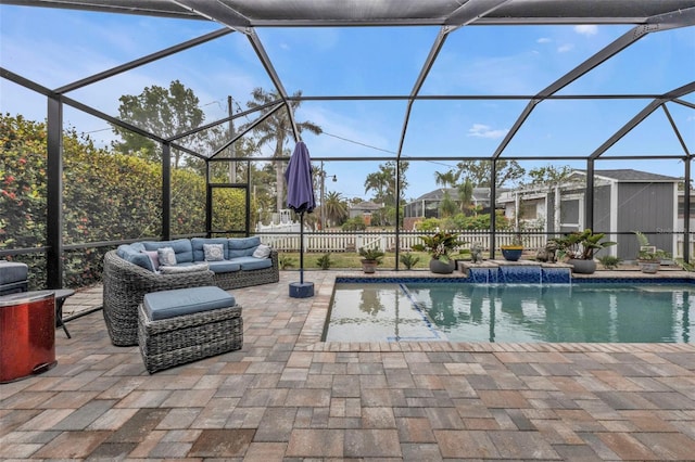 view of swimming pool featuring pool water feature, glass enclosure, an outdoor hangout area, and a patio area