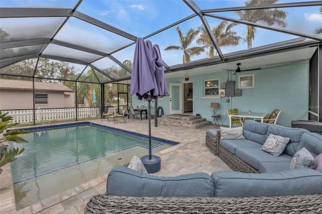 view of pool with a lanai, outdoor lounge area, and a patio